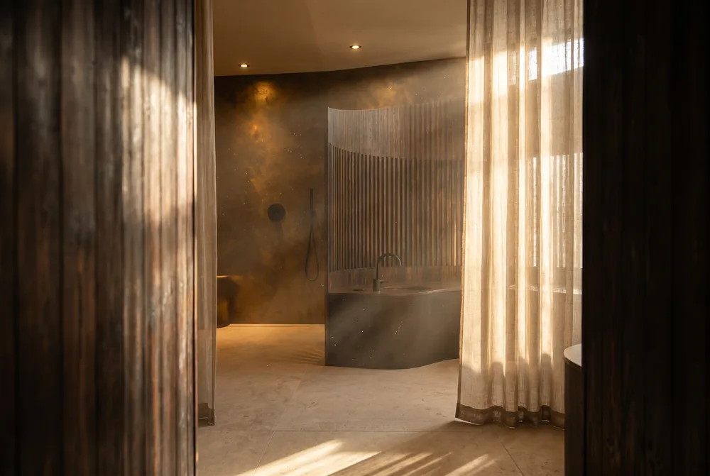 Soft light through sheer linen drapery.